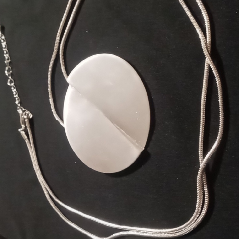Reversable circle pendant necklace 30+2inches long in silver tone.